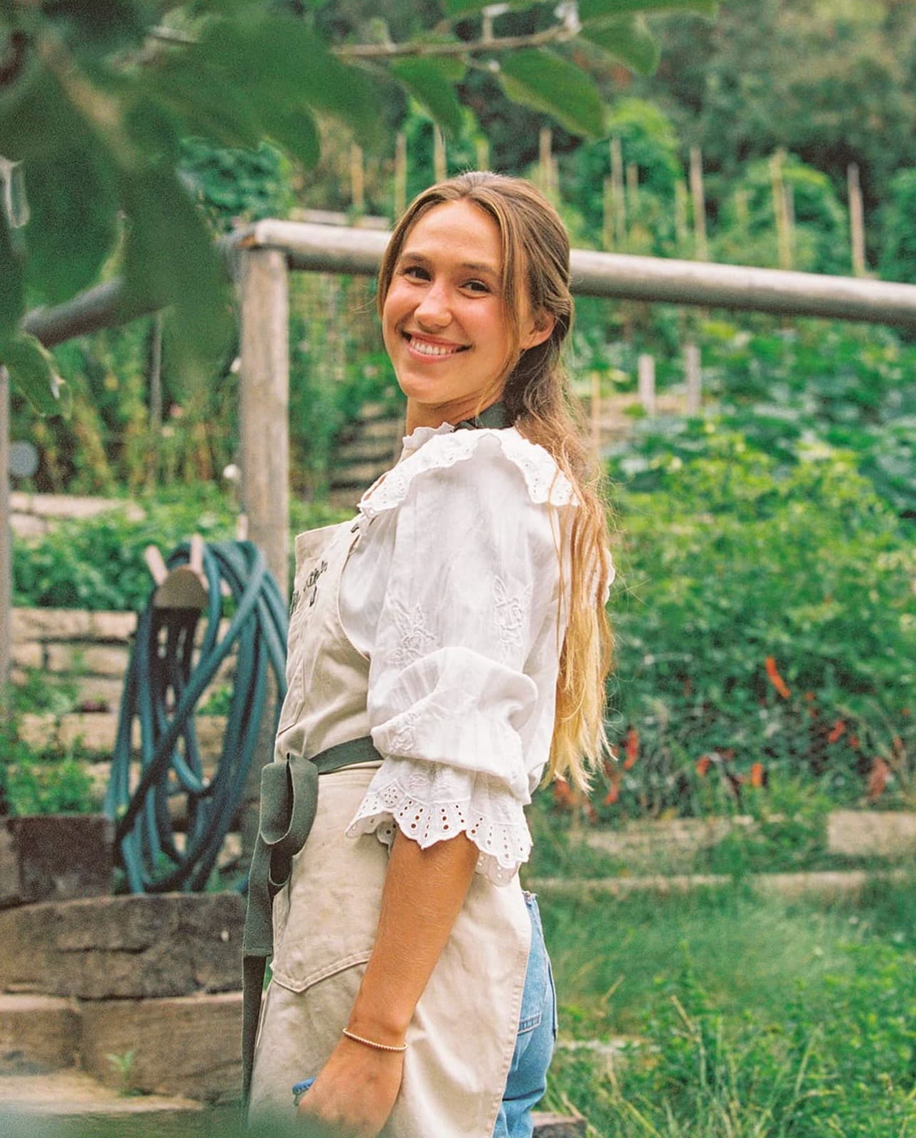 Chelsey Harlien, founder of Lighthearted Kitchen, in a garden